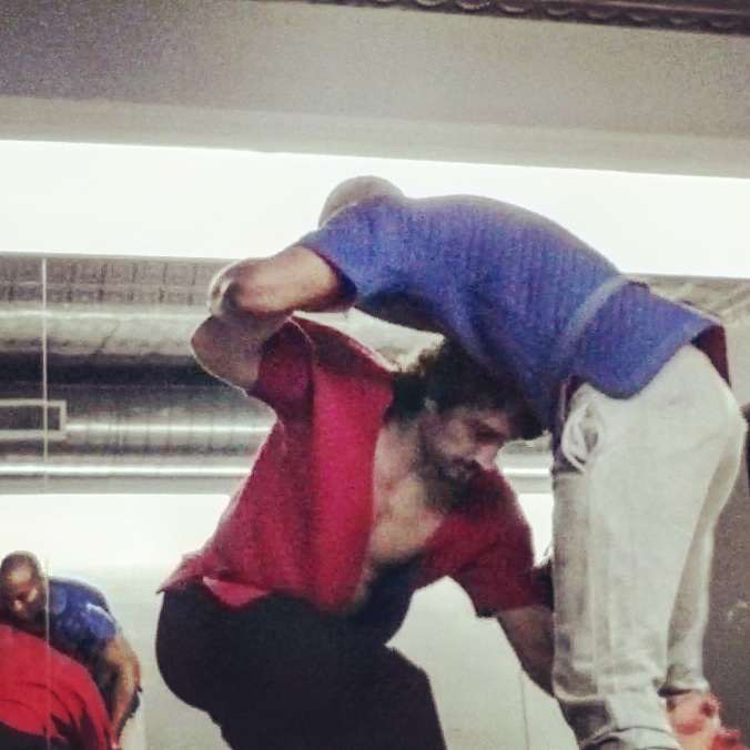 Two people practicing a shuai jiao throw.